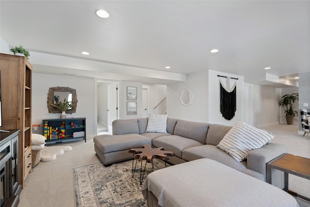 living room featuring light colored carpet, stairs, baseboards, and recessed lighting