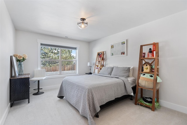 bedroom featuring light carpet, baseboards, and visible vents
