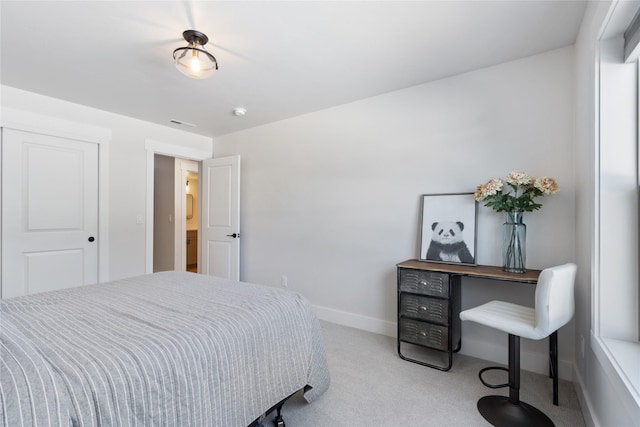 carpeted bedroom featuring baseboards and visible vents