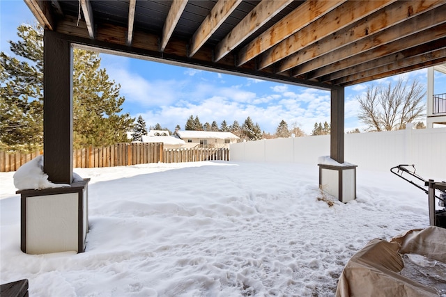 yard covered in snow with a fenced backyard