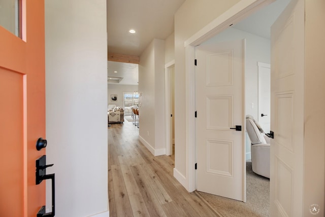 hallway with light wood-style floors, recessed lighting, and baseboards