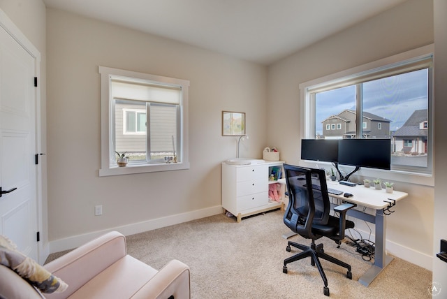 home office with light carpet and baseboards