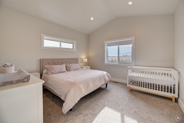 bedroom featuring vaulted ceiling, carpet floors, multiple windows, and baseboards