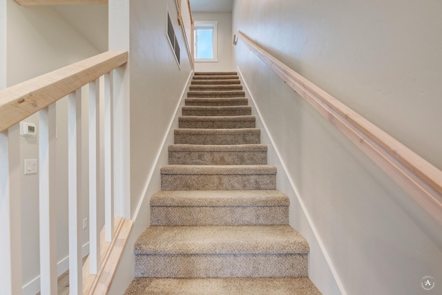 stairway featuring visible vents