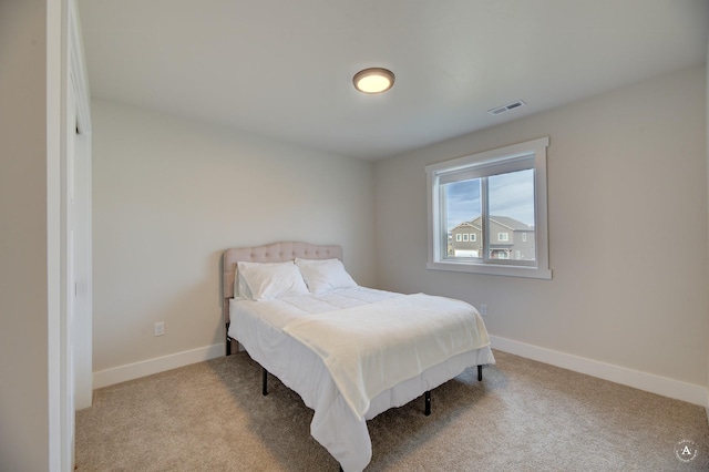 bedroom featuring light colored carpet, visible vents, and baseboards