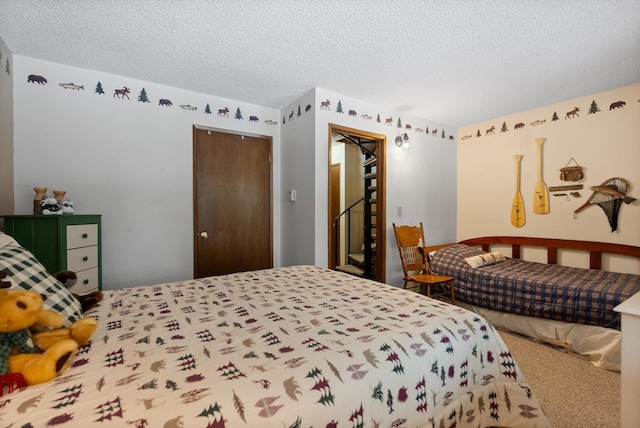 bedroom with carpet floors, a closet, and a textured ceiling