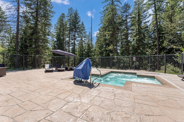 view of swimming pool featuring an in ground hot tub, a patio, and fence