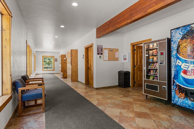 hallway with baseboards, beamed ceiling, stone finish floor, and recessed lighting