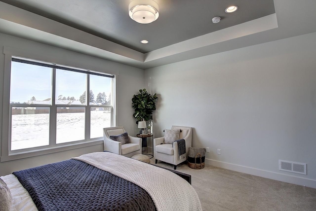 carpeted bedroom featuring baseboards, visible vents, a tray ceiling, and recessed lighting