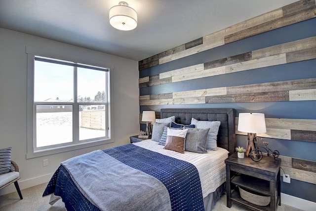 bedroom with wood walls, baseboards, and carpet flooring