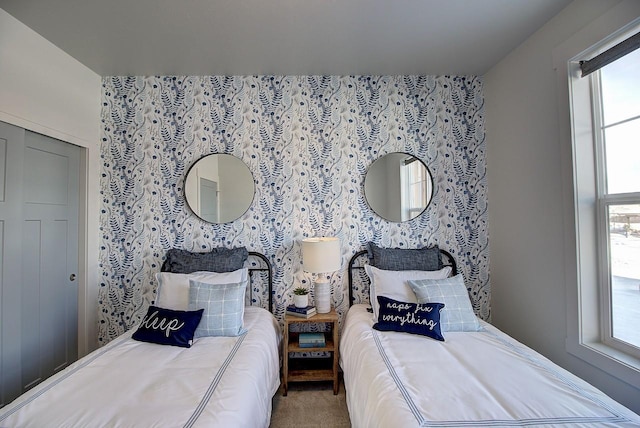 carpeted bedroom featuring wallpapered walls