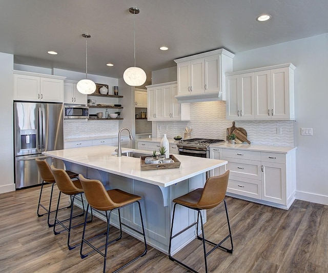 kitchen with pendant lighting, open shelves, stainless steel appliances, light countertops, and white cabinetry