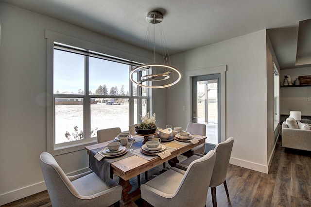 dining room with dark wood-style floors, baseboards, and a notable chandelier