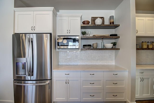 kitchen featuring white cabinetry, appliances with stainless steel finishes, and light countertops