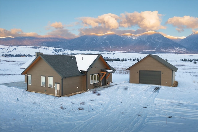 rustic home with a detached garage and a mountain view