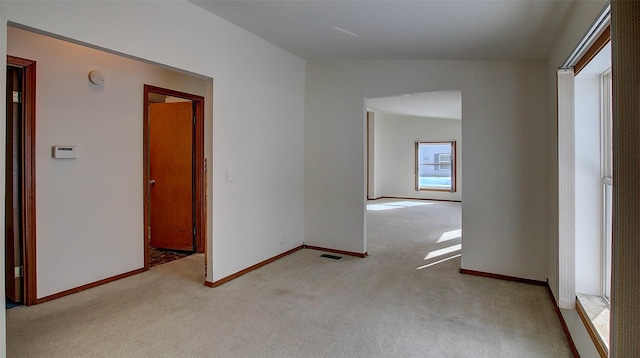 unfurnished room with light carpet, baseboards, and visible vents