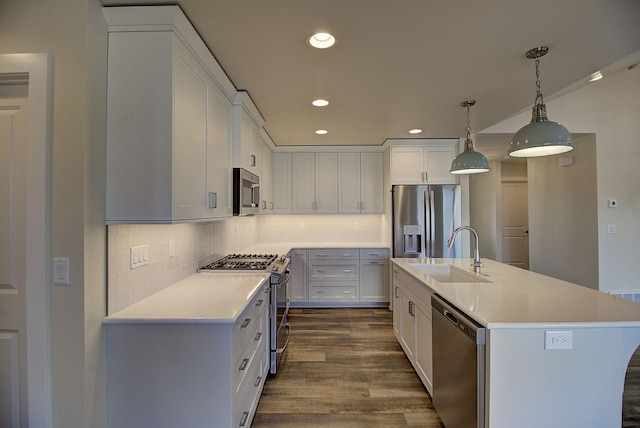 kitchen featuring stainless steel appliances, light countertops, a sink, and white cabinetry