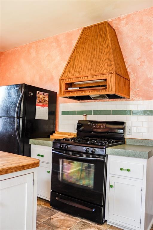 202 3rd St, Havre, MT 59501 - kitchen with black appliances, custom range hood, white cabinetry, and wooden counters