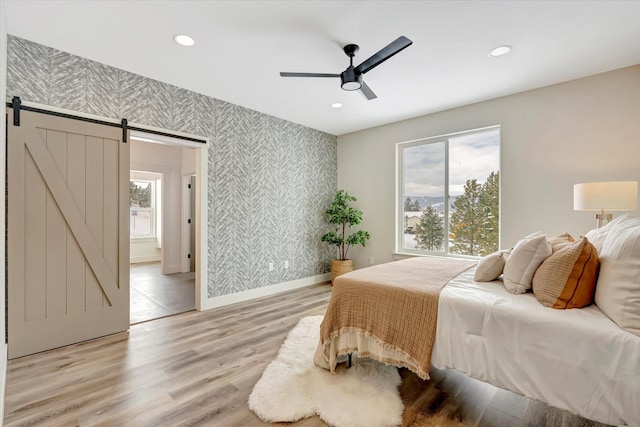 bedroom with light wood-type flooring, wallpapered walls, baseboards, and recessed lighting