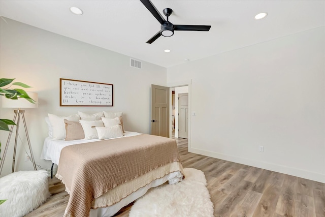 bedroom featuring light wood-type flooring, visible vents, and recessed lighting