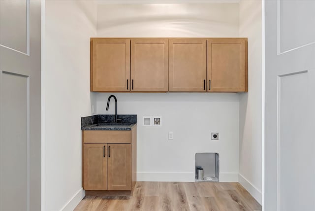 clothes washing area with light wood finished floors, hookup for a washing machine, a sink, electric dryer hookup, and baseboards