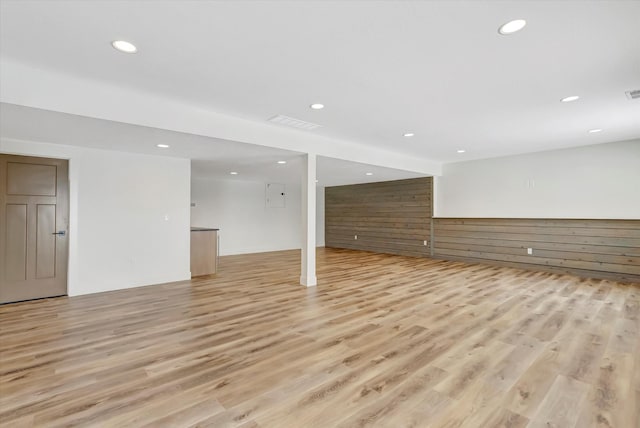 finished below grade area featuring recessed lighting and light wood-style flooring