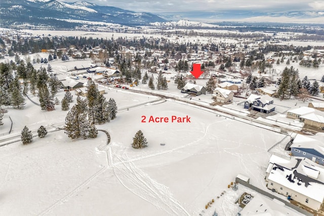 snowy aerial view with a mountain view