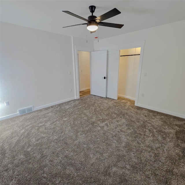 unfurnished bedroom featuring carpet floors, visible vents, and baseboards