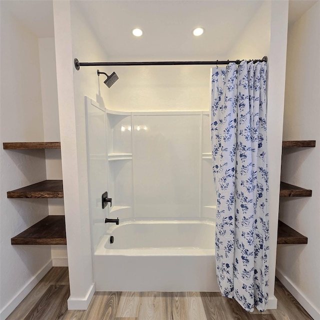 full bathroom with shower / tub combo, baseboards, wood finished floors, and recessed lighting