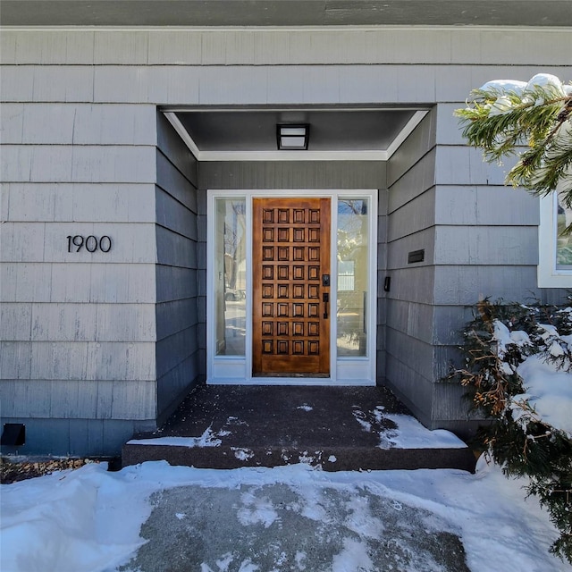 view of snow covered property entrance