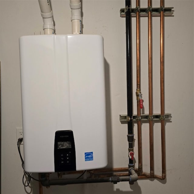 utility room featuring tankless water heater