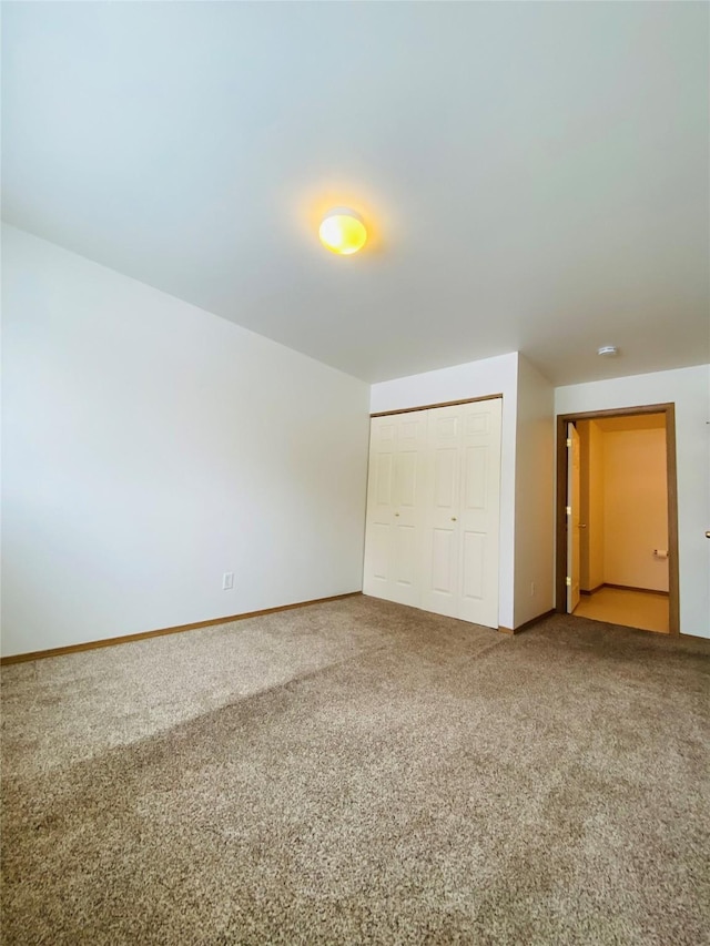 unfurnished bedroom with carpet floors and a closet