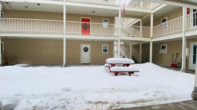 view of snow covered rear of property