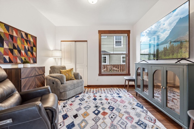 living room with dark wood-style flooring and baseboards