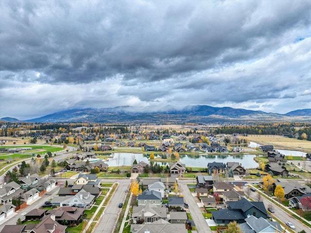 drone / aerial view featuring a residential view and a water and mountain view