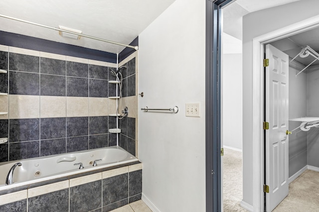 bathroom featuring a combined bath / shower with jetted tub and baseboards