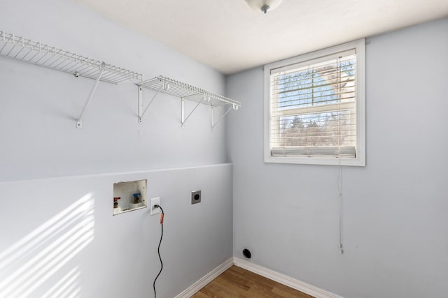 laundry area with laundry area, baseboards, wood finished floors, hookup for an electric dryer, and washer hookup