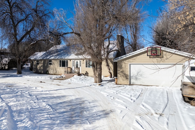 view of front of house featuring a garage and an outbuilding