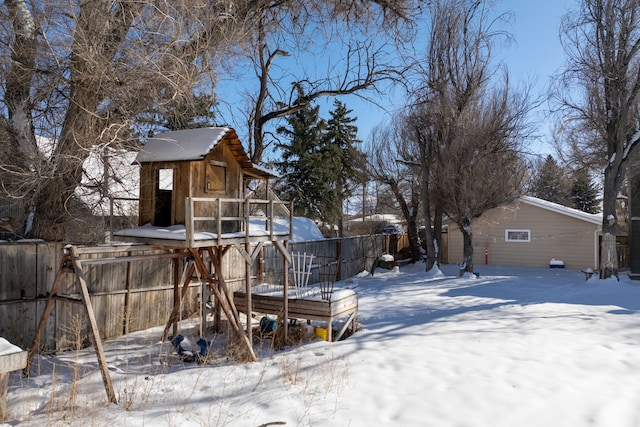 yard covered in snow with fence