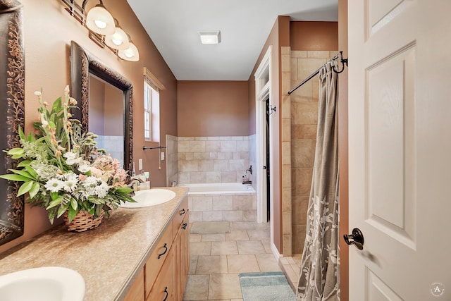 bathroom with a garden tub, a sink, a tile shower, and double vanity