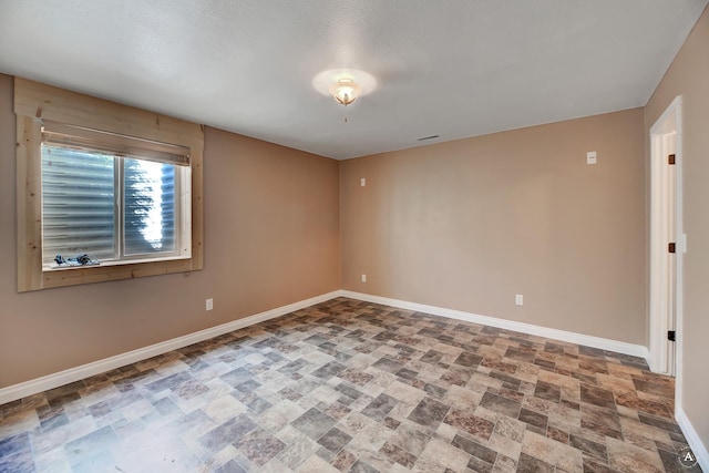 empty room with baseboards