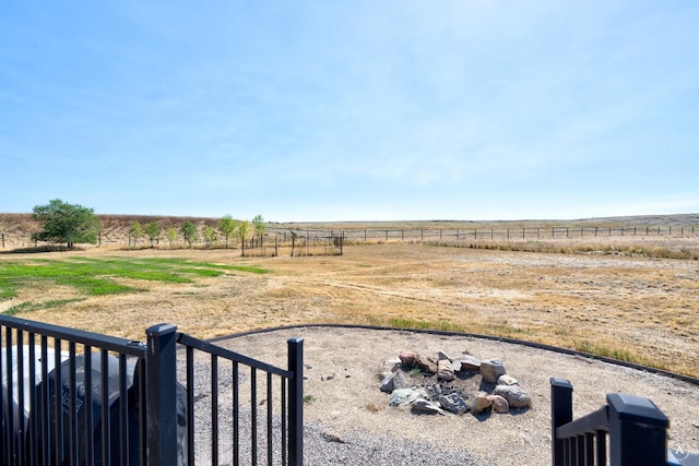 view of yard with a rural view and fence