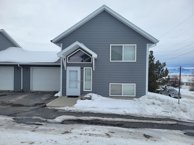 view of front of property with a garage and aphalt driveway