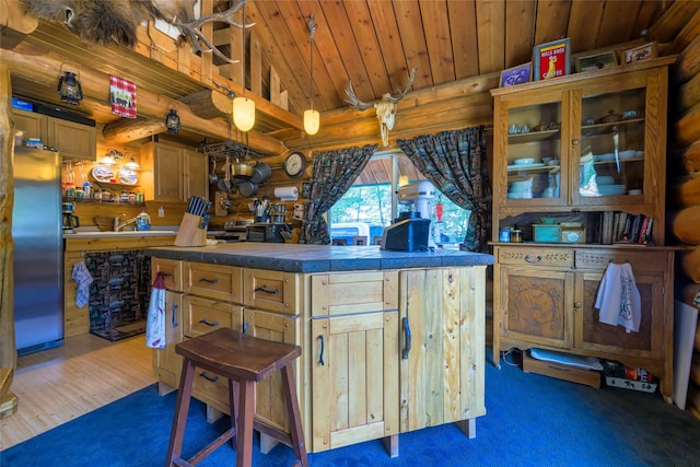 kitchen featuring high vaulted ceiling, wooden ceiling, rustic walls, stainless steel fridge, and glass insert cabinets