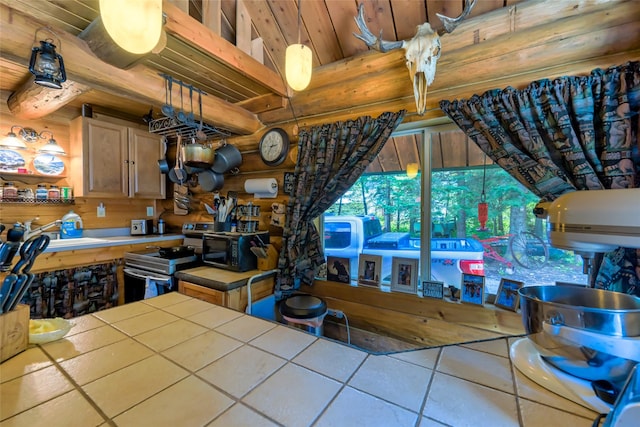 kitchen featuring tile counters, rustic walls, electric range, black microwave, and beamed ceiling