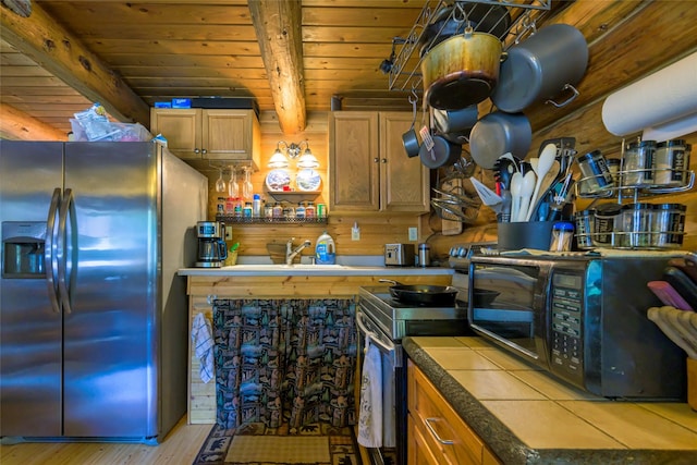 kitchen featuring brown cabinetry, wooden ceiling, stainless steel appliances, light wood-type flooring, and beam ceiling