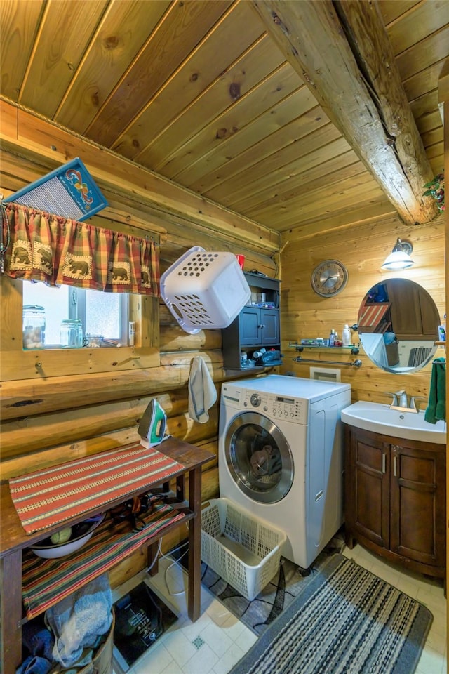 laundry area featuring washer / clothes dryer, cabinet space, rustic walls, a sink, and wooden ceiling