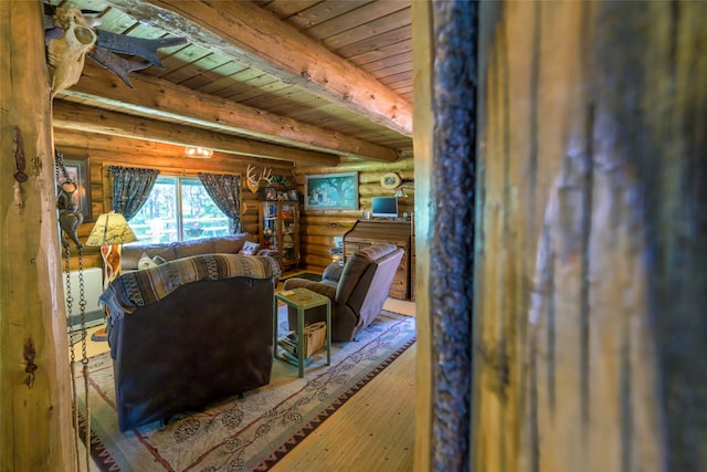 interior space featuring beamed ceiling, wooden ceiling, wood finished floors, and rustic walls