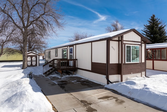 view of front of house with a shed and an outbuilding