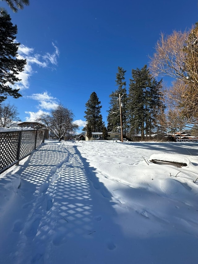 snowy yard with fence